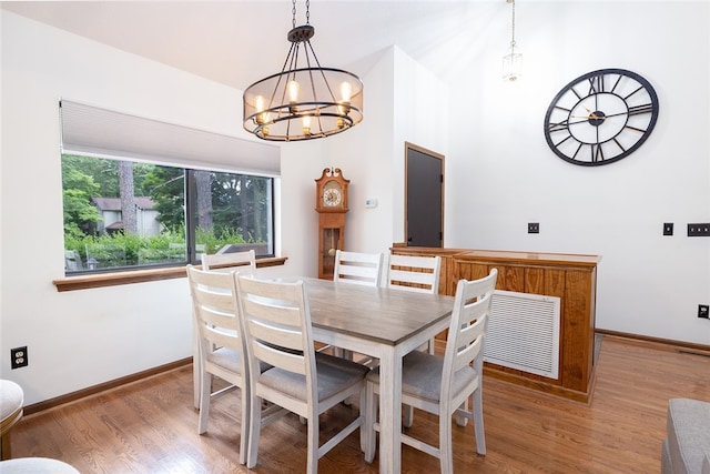 dining area featuring an inviting chandelier and hardwood / wood-style floors