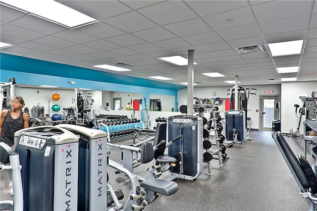 gym with a paneled ceiling