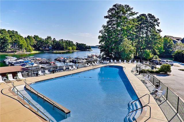 view of swimming pool with a water view