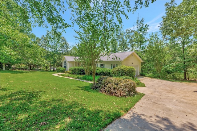 view of front of home with a garage and a front lawn