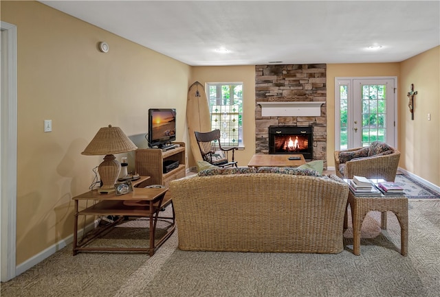 living room with carpet, a fireplace, and a wealth of natural light