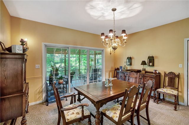 dining space featuring light carpet and a notable chandelier