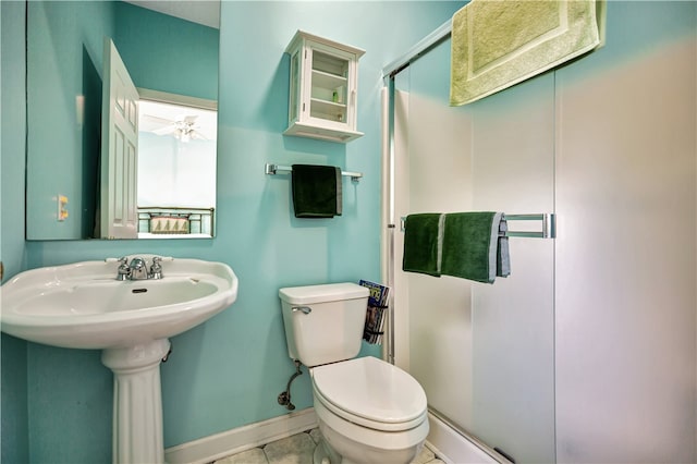 bathroom with walk in shower, ceiling fan, toilet, sink, and tile patterned floors