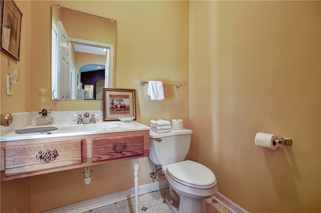 bathroom featuring tile patterned flooring, vanity, and toilet