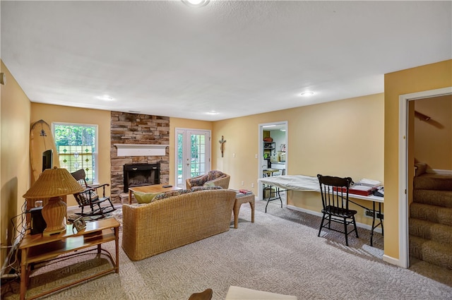 living room with carpet flooring and a stone fireplace