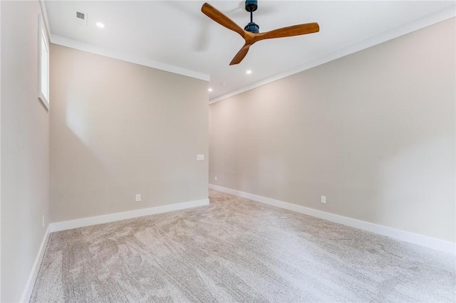 spare room featuring crown molding, ceiling fan, and light carpet