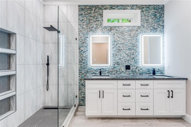 bathroom featuring tiled shower and vanity