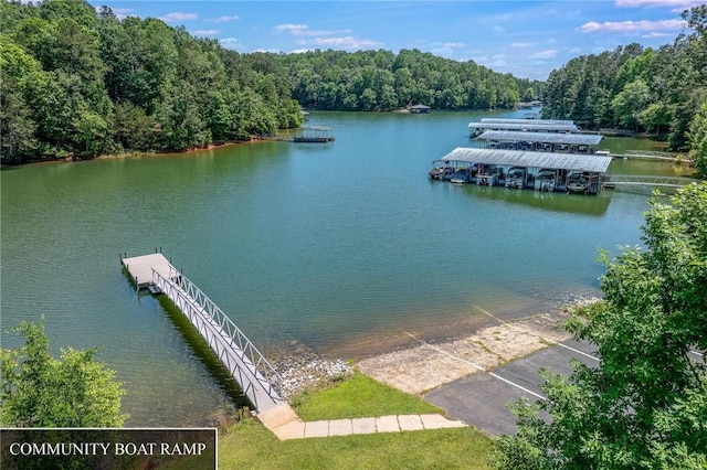 exterior space featuring a forest view and a floating dock