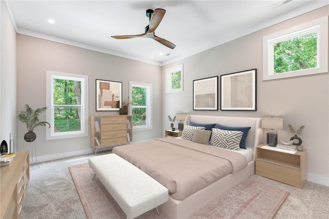 carpeted bedroom with multiple windows, ornamental molding, and ceiling fan