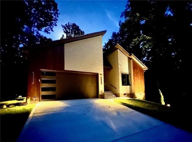 view of front of home with a garage and concrete driveway