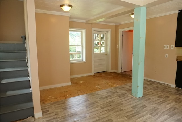 entryway featuring ornamental molding and light hardwood / wood-style flooring