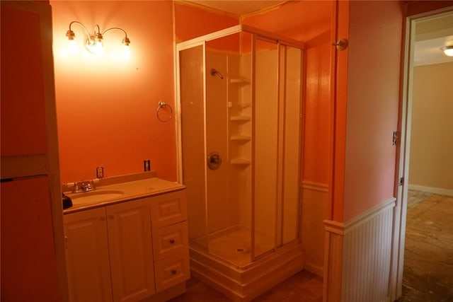 bathroom featuring walk in shower and vanity