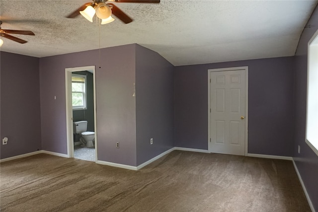 bonus room featuring vaulted ceiling, ceiling fan, carpet flooring, and a textured ceiling