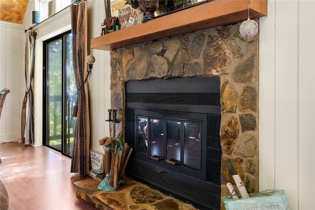 room details with wood walls and hardwood / wood-style floors