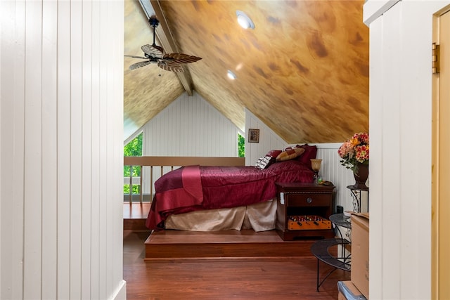 bedroom featuring vaulted ceiling with beams, wooden walls, and dark wood-type flooring