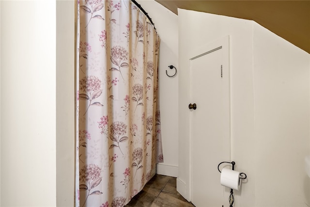 bathroom with tile patterned floors and a shower with shower curtain