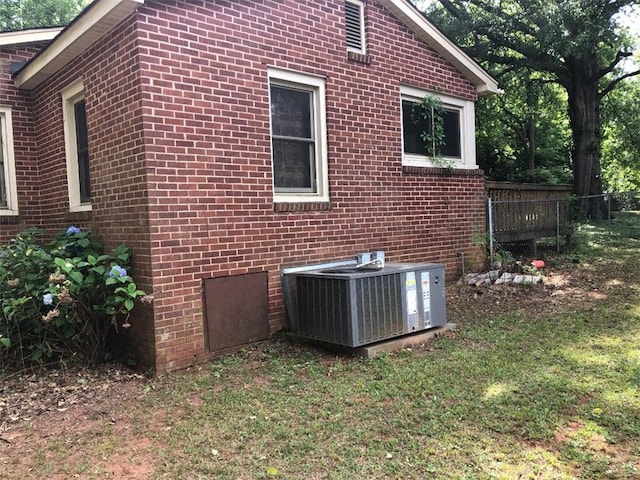 view of home's exterior featuring a yard and central AC