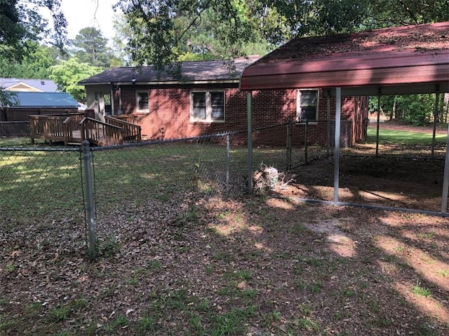 back of property featuring a yard and a carport