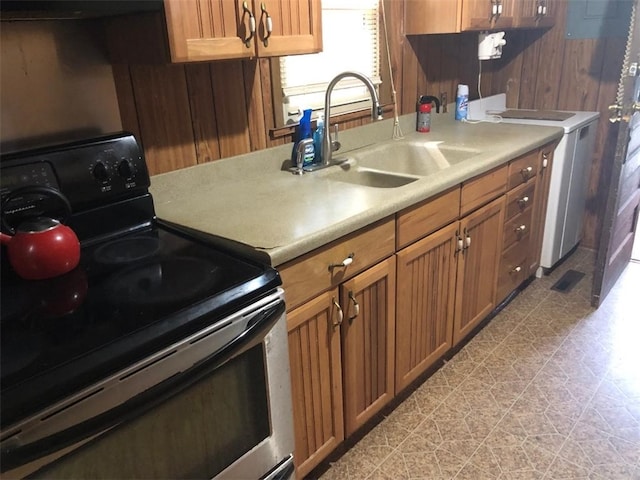 kitchen featuring electric range and sink