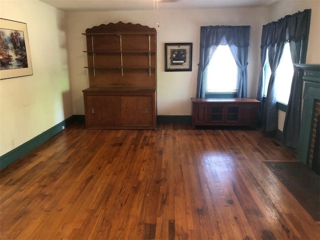 empty room with dark hardwood / wood-style flooring