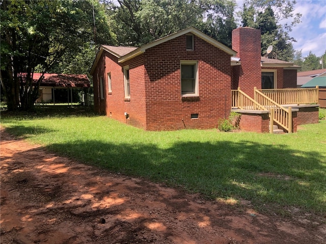 rear view of house with a deck and a yard