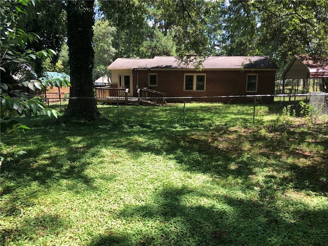 view of yard with a wooden deck