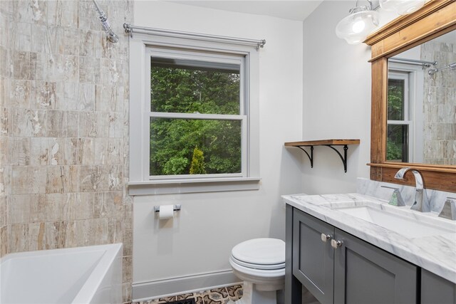 full bathroom with tiled shower / bath combo, vanity, and toilet