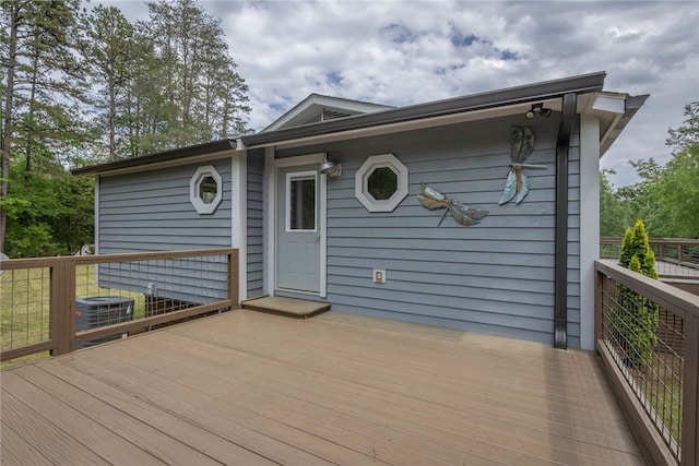 wooden terrace featuring cooling unit