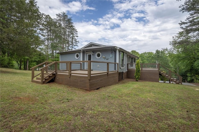 back of house with stairway, a lawn, and a deck