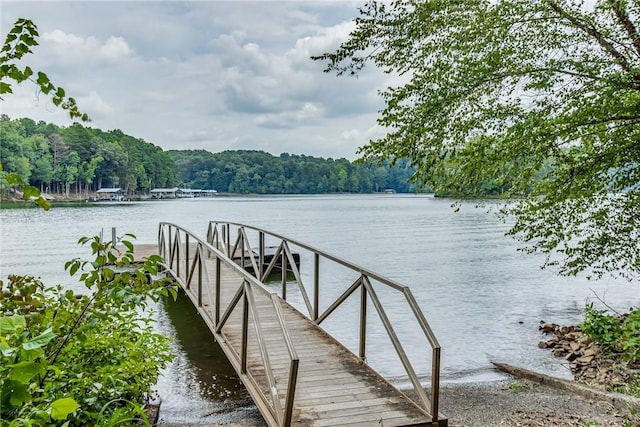 dock area featuring a view of trees and a water view