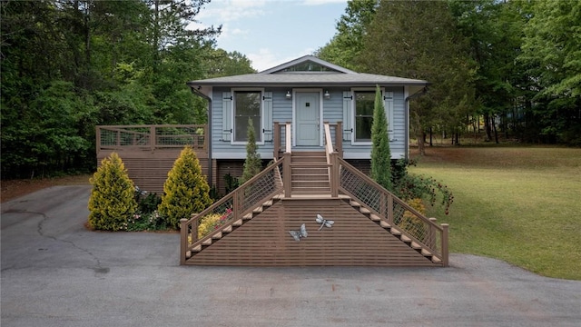 bungalow-style home with stairs and a front yard