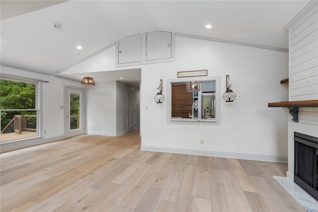 unfurnished living room featuring light wood finished floors, a fireplace, baseboards, lofted ceiling, and recessed lighting