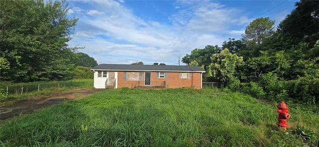 view of front facade featuring fence and brick siding