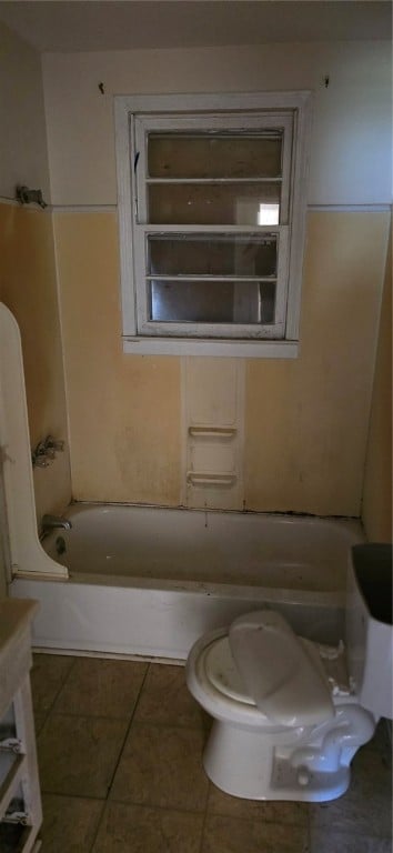 bathroom with tile patterned flooring and toilet