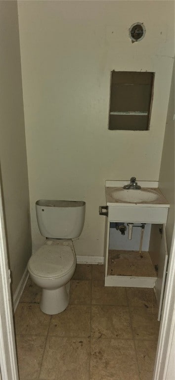 bathroom featuring sink, toilet, and tile patterned floors