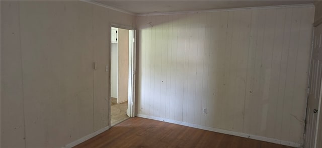 spare room featuring hardwood / wood-style floors and ornamental molding