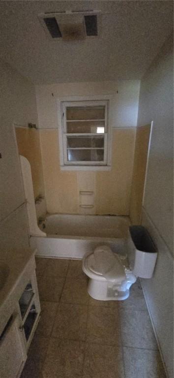 bathroom featuring toilet and tile patterned flooring