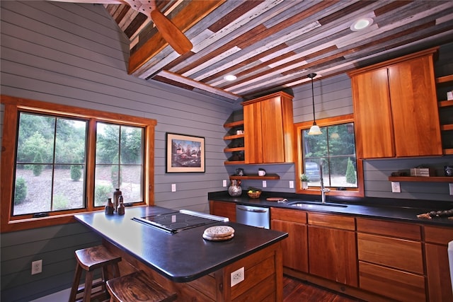 kitchen featuring stainless steel dishwasher, hanging light fixtures, electric stovetop, dark hardwood / wood-style flooring, and beamed ceiling