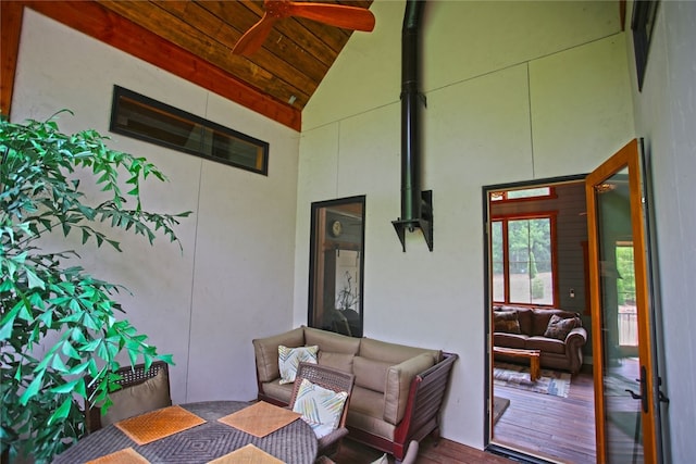 living room with wood ceiling, hardwood / wood-style floors, high vaulted ceiling, and ceiling fan