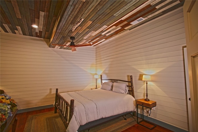 bedroom with wood ceiling and dark wood-type flooring