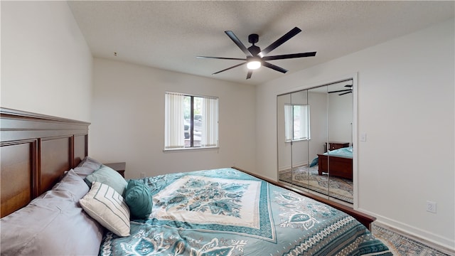 bedroom featuring a textured ceiling, multiple windows, and ceiling fan