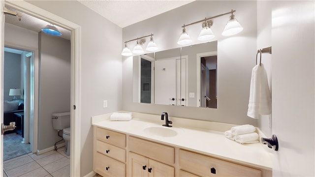 bathroom with tile patterned floors, toilet, and vanity