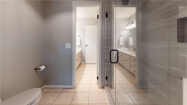 bathroom featuring vanity, tile patterned flooring, and toilet