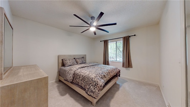 carpeted bedroom with a textured ceiling and ceiling fan