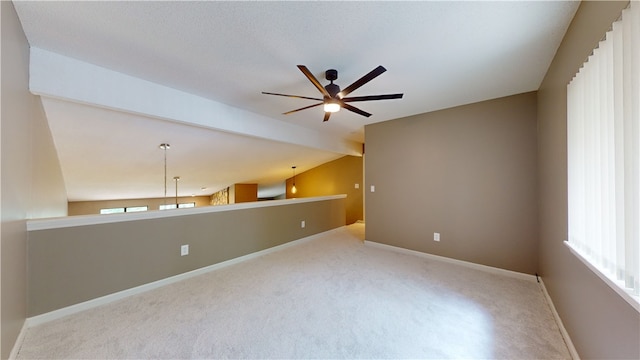 carpeted empty room featuring lofted ceiling and ceiling fan