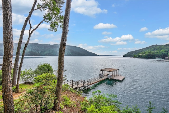 view of dock with a water and mountain view