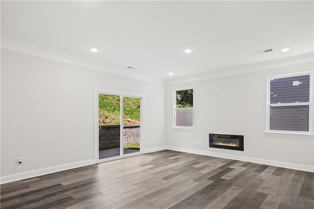 spare room featuring crown molding and dark hardwood / wood-style flooring