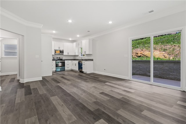 unfurnished living room featuring ornamental molding, sink, and dark hardwood / wood-style floors