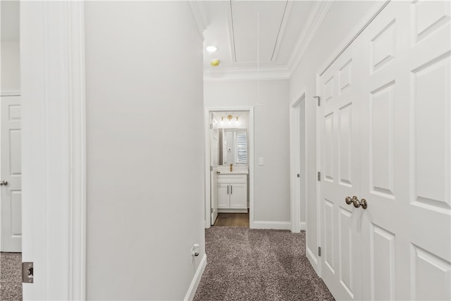 hall with crown molding and dark carpet