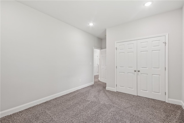 unfurnished bedroom with a closet and carpet flooring